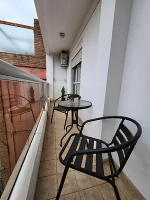 a small balcony with a table and chairs at Obispo Oro 451 - Nueva Córdoba in Cordoba