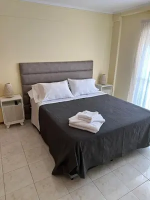 a bedroom with a bed with two towels on it at Obispo Oro 451 - Nueva Córdoba in Cordoba