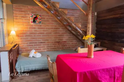a room with a table with a red table cloth at La Laguna - Cabañas de Troncos in Merlo