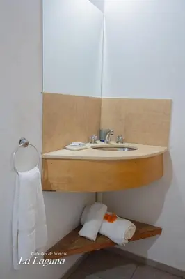 a bathroom with a sink and a mirror at La Laguna - Cabañas de Troncos in Merlo