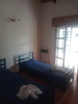 a bedroom with two beds and a window at Casa 3 Habitaciones, 2 baños pileta a compartir con el anfitrion - in Cordoba