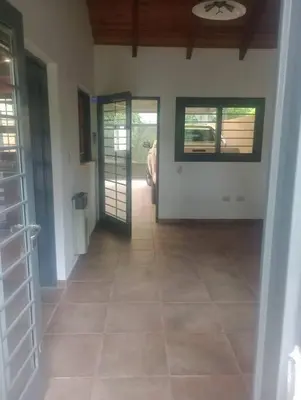 a hallway of a house with doors and a tile floor at Casa 3 Habitaciones, 2 baños pileta a compartir con el anfitrion - in Cordoba