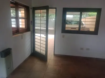 a hallway with doors and windows in a house at Casa 3 Habitaciones, 2 baños pileta a compartir con el anfitrion - in Cordoba