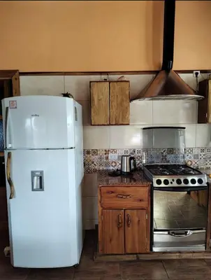 a kitchen with a white refrigerator and a stove at Casa Del Arroyo in Arroyo de Los Patos