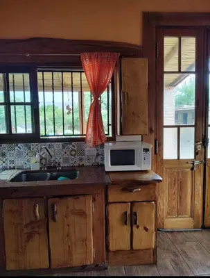 a kitchen with a sink and a microwave at Casa Del Arroyo in Arroyo de Los Patos
