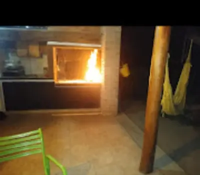 a kitchen with a oven with a fire in it at Casa Del Arroyo in Arroyo de Los Patos