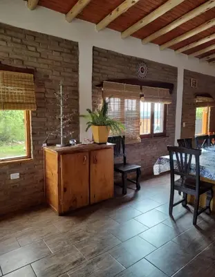 a kitchen with a table and chairs in a room at Casa Del Arroyo in Arroyo de Los Patos