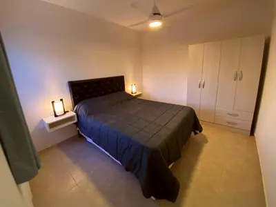a bedroom with a bed and two lights on a cabinet at Complejo Costa Linda in Villa Carlos Paz