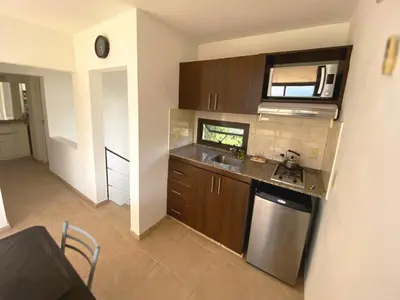 a kitchen with a sink and a counter top at Complejo Costa Linda in Villa Carlos Paz