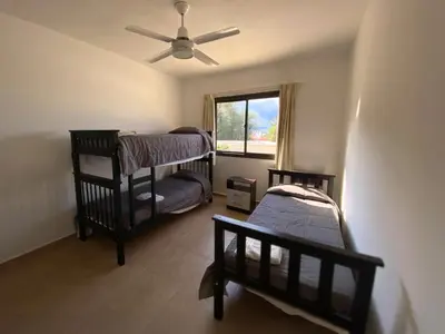 a bedroom with two bunk beds and a ceiling fan at Complejo Costa Linda in Villa Carlos Paz
