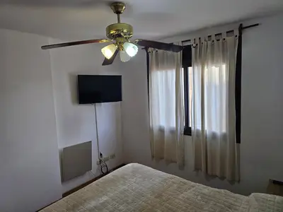 a bedroom with a ceiling fan and a bed at Amplio Depto en Pleno Centro! in Cordoba