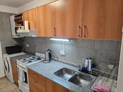 a kitchen with a sink and a stove at Amplio Depto en Pleno Centro! in Cordoba