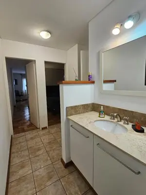 a bathroom with a sink and a mirror at Amplio Depto en Pleno Centro! in Cordoba