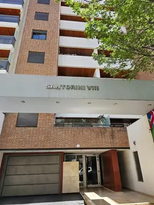 a brick building with a garage in front of it at Amplio Depto en Pleno Centro! in Cordoba