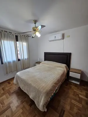 a bedroom with a bed and a ceiling fan at Amplio Depto en Pleno Centro! in Cordoba