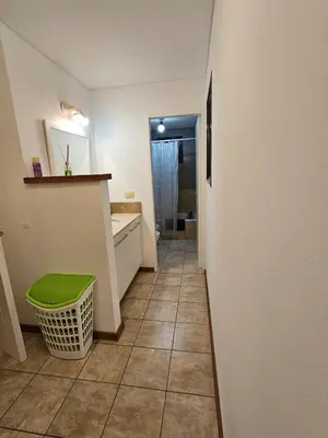 a hallway of a bathroom with a green stool at Amplio Depto en Pleno Centro! in Cordoba