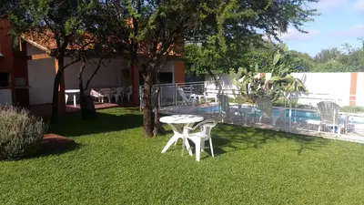 a patio with a table and chairs in a yard at Cabañas Luna del Sur in Merlo