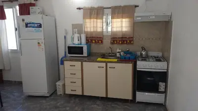 a small kitchen with a refrigerator and a microwave at Cabañas Luna del Sur in Merlo