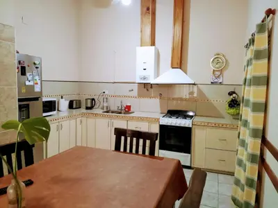 a kitchen with a table and a stove top oven at Casa Arenales in Almafuerte