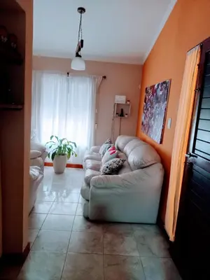 a living room with a couch in the corner of a room at Casa Arenales in Almafuerte