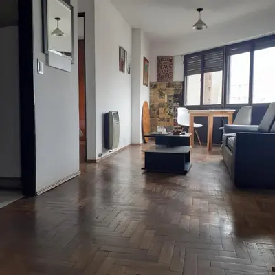 a living room with a couch and a tv at Pilsen II Guemes in Cordoba