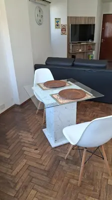a living room with a table and a couch at Pilsen II Guemes in Cordoba