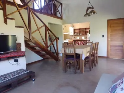 a kitchen and dining room with a table and chairs at La Serranita in Santa Rosa de Calamuchita