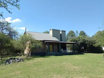 a house in the middle of a field at La Serranita in Santa Rosa de Calamuchita