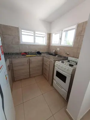 a kitchen with a stove and a sink in it at Casa Villa Rumipal in Villa Rumipal