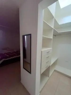 a white closet with a mirror on a wall at Casa Villa Rumipal in Villa Rumipal