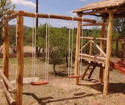 a playground with a bench and a swing at VASOS Y BESOS - Cabaña 1 in Villa Parque Siquiman