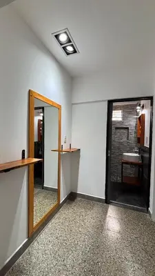 an empty room with a mirror and a sink at Casa Familia Reynoso in Mina Clavero