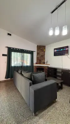 a living room with a couch and a table at Casa Familia Reynoso in Mina Clavero