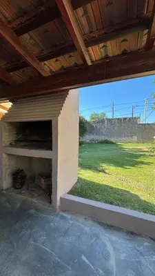 an outdoor fireplace with a view of a field at Casa Familia Reynoso in Mina Clavero