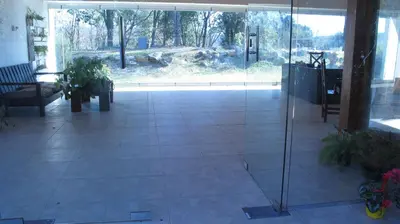 a lobby with a glass door in a building at Posada La Rosita in Santa Rosa de Calamuchita