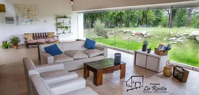 a living room with a couch and a table at Posada La Rosita in Santa Rosa de Calamuchita