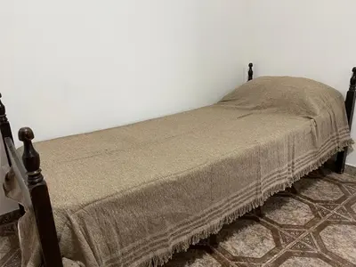 a bedroom with a bed with a blanket on it at Cabañas Emilia in Mina Clavero