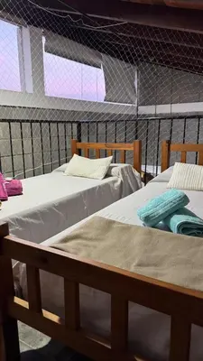 a couple of beds in a room at La Calandria, Casa de campo in La Estancia