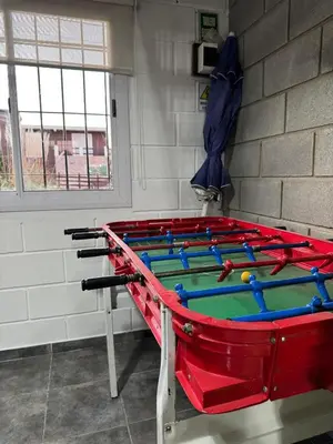 a pool table in a room with a blue umbrella at La Calandria, Casa de campo in La Estancia