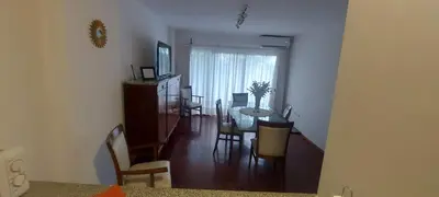 a dining room and living room with a table and chairs at Cofico Tradicional in Cordoba