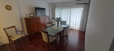 a dining room with a table and chairs and a television at Cofico Tradicional in Cordoba