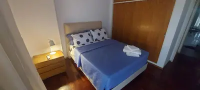 a small bedroom with a bed with a blue comforter at Cofico Tradicional in Cordoba