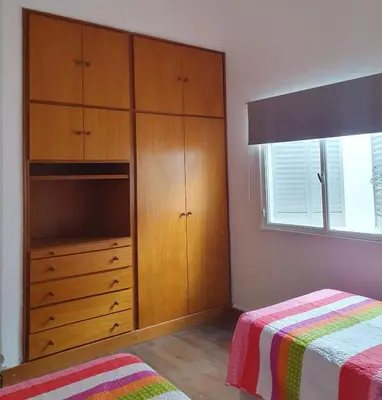 a bedroom with a large wooden cabinet and a bed at DEPARTAMENTO RIO TERCERO in Río Tercero