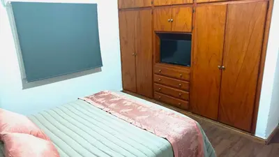 a bedroom with a tv and a cabinet with a television at DEPARTAMENTO RIO TERCERO in Río Tercero