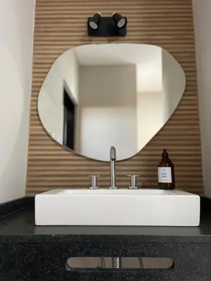 a bathroom sink with a large mirror above it at La Morada Almafuerte in Almafuerte