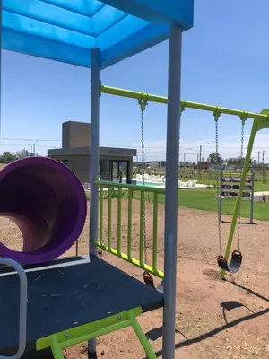 a playground with a slide and a swing at La Morada Almafuerte in Almafuerte
