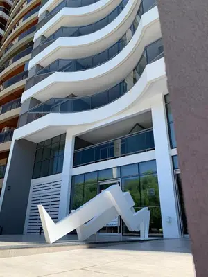 a large building with a sculpture in front of it at Duplex Nva Cba, frente al Parque Sarmiento. Excdelentes Amenities in Cordoba