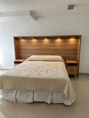 a bedroom with a large bed with a wooden headboard at Duplex Nva Cba, frente al Parque Sarmiento. Excdelentes Amenities in Cordoba