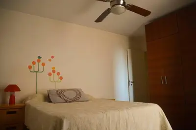 a bedroom with a bed with a ceiling fan at Departamento en Bv. San Juan in Cordoba