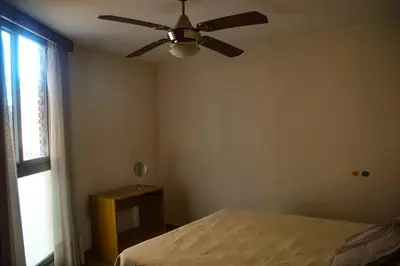 a bedroom with a ceiling fan and a bed at Departamento en Bv. San Juan in Cordoba